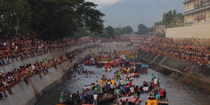 People gathering along the river in Naga City, Philippines