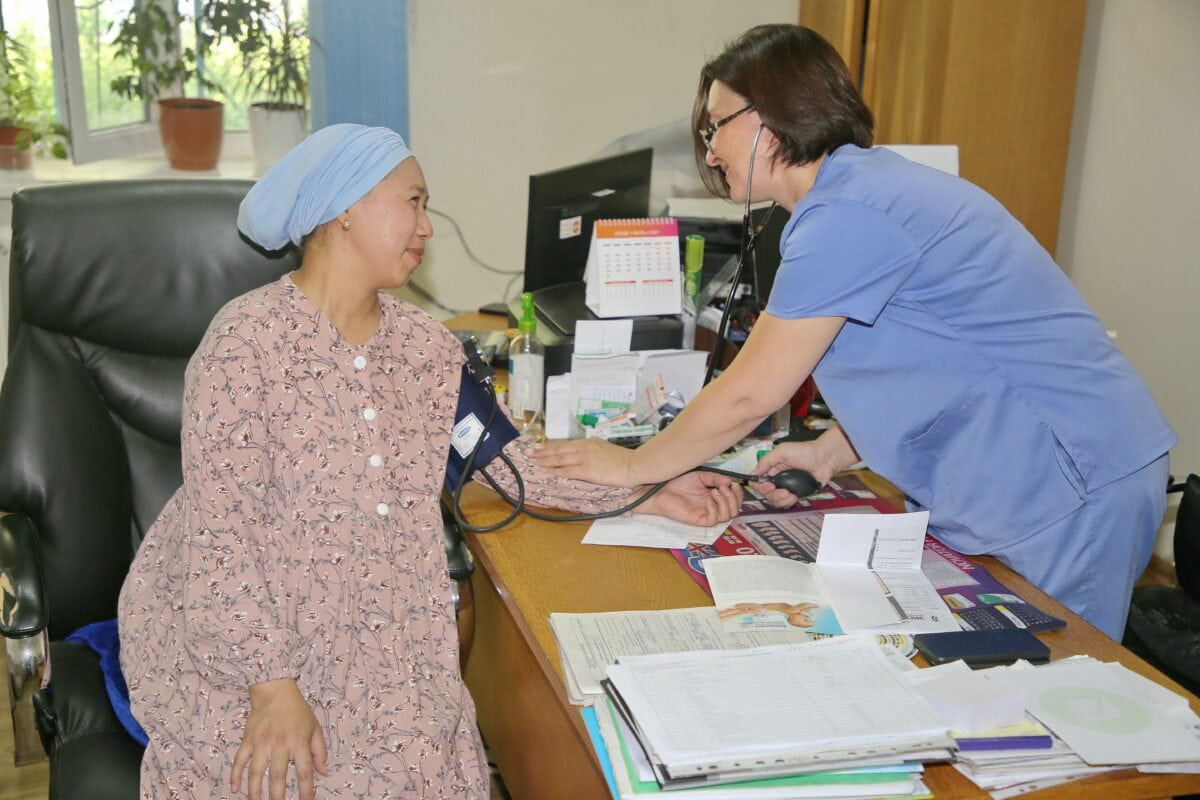 Dr Rufina Kozhobekova measures a woman’s blood pressure
